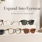 Website banner showing premium optical frames and sunglasses on a minimalist display, with blurred apparel in the background, illustrating how fashion and apparel brands expand into eyewear through private label manufacturing.