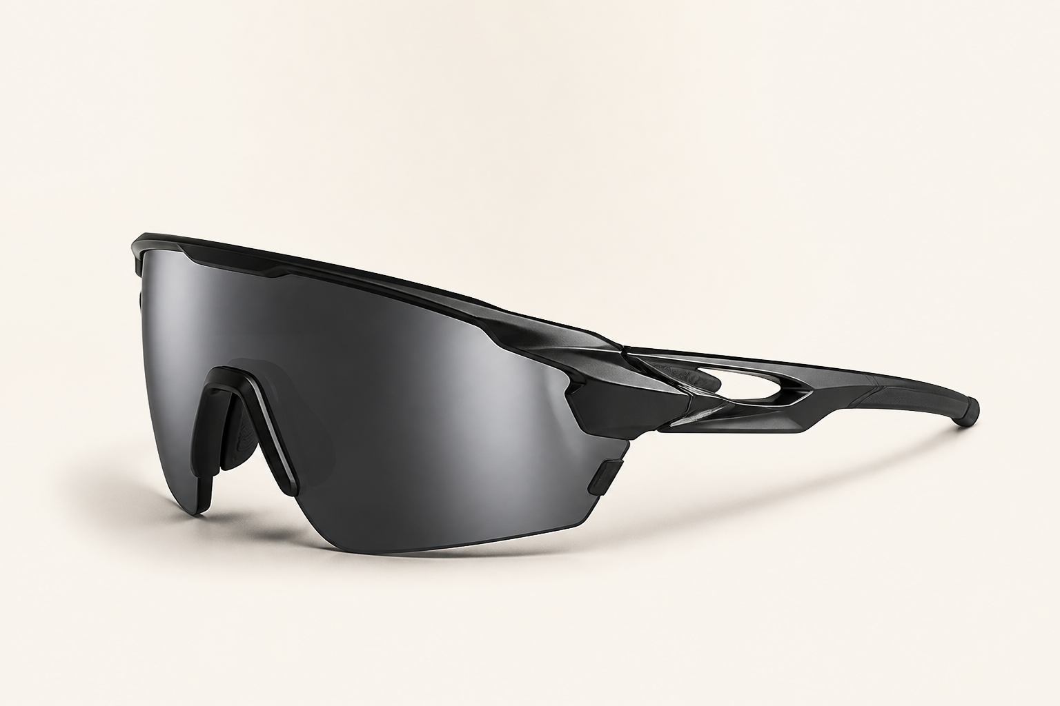 Futuristic black sporty wraparound sunglasses with a curved smoke lens on a warm gray background