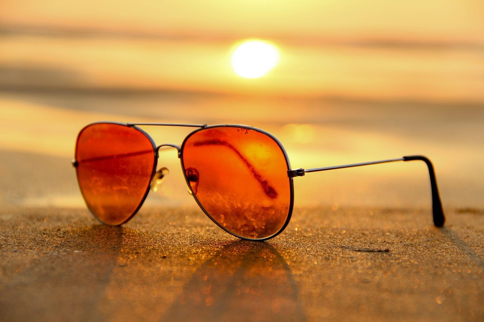 Brazil eyewear market 2026 unbranded beach sunglasses – Concept Eyewear Brazil eyewear market 2026: unbranded aviator sunglasses on beach sand at sunset, no logos