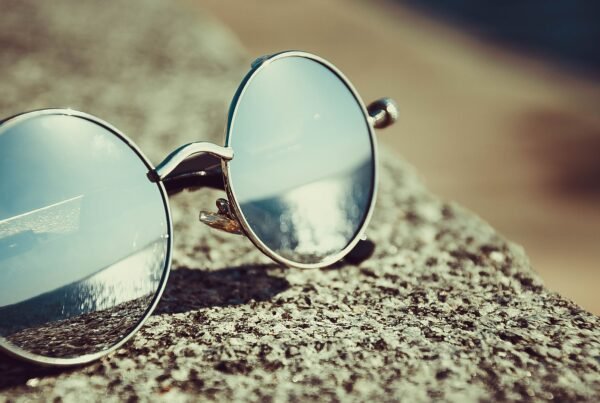 Fashion-first open-ear Bluetooth glasses with round metal frames in a lifestyle editorial still